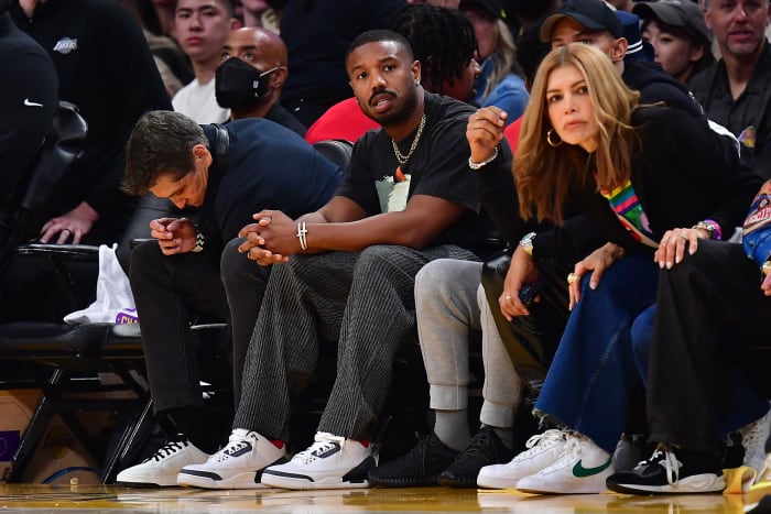 Michael B. Jordan sits courtside at an NBA game.
